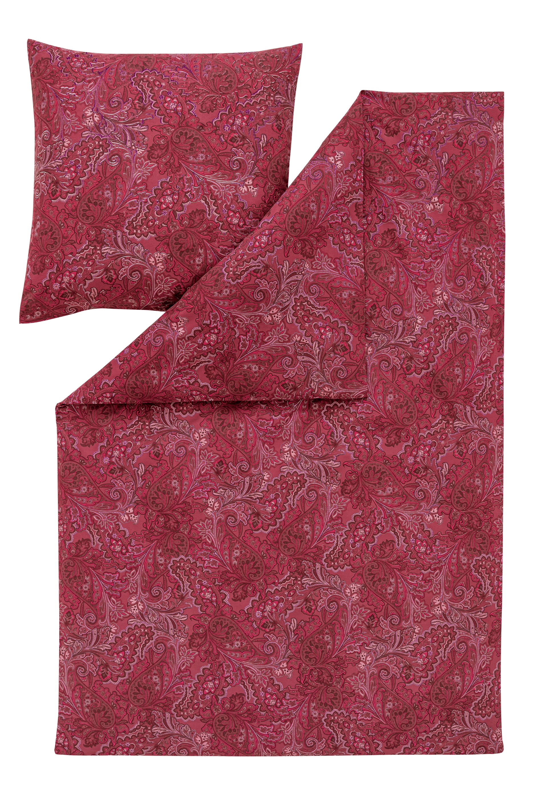 Ein Kopfkissen und eine Bettdecke bezogen mit Edel-Flanell Bettwaesche von Essenza mit einem Muster aus Blueten in der Farbe Rot. Modell Paola Purpur.