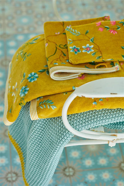 Ein Stapel aus mehreren Handtuechern von PIP STUDIO die aufeinander liegen mit Muster aus Blumen in der Farbe Gelb. Modell Les Fleurs Yellow.