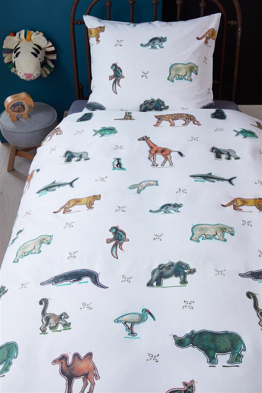 In einem Kinderzimmer steht ein Kinderbett mit einem Kopfkissen und einer Bettdecke bezogen mit kuscheliger beddinghouse Bettwaesche aus 100 Prozent Baumwolle mit Illustrationen von wilden Tieren in der Farbe Weiss. Modell Wild Animals.
