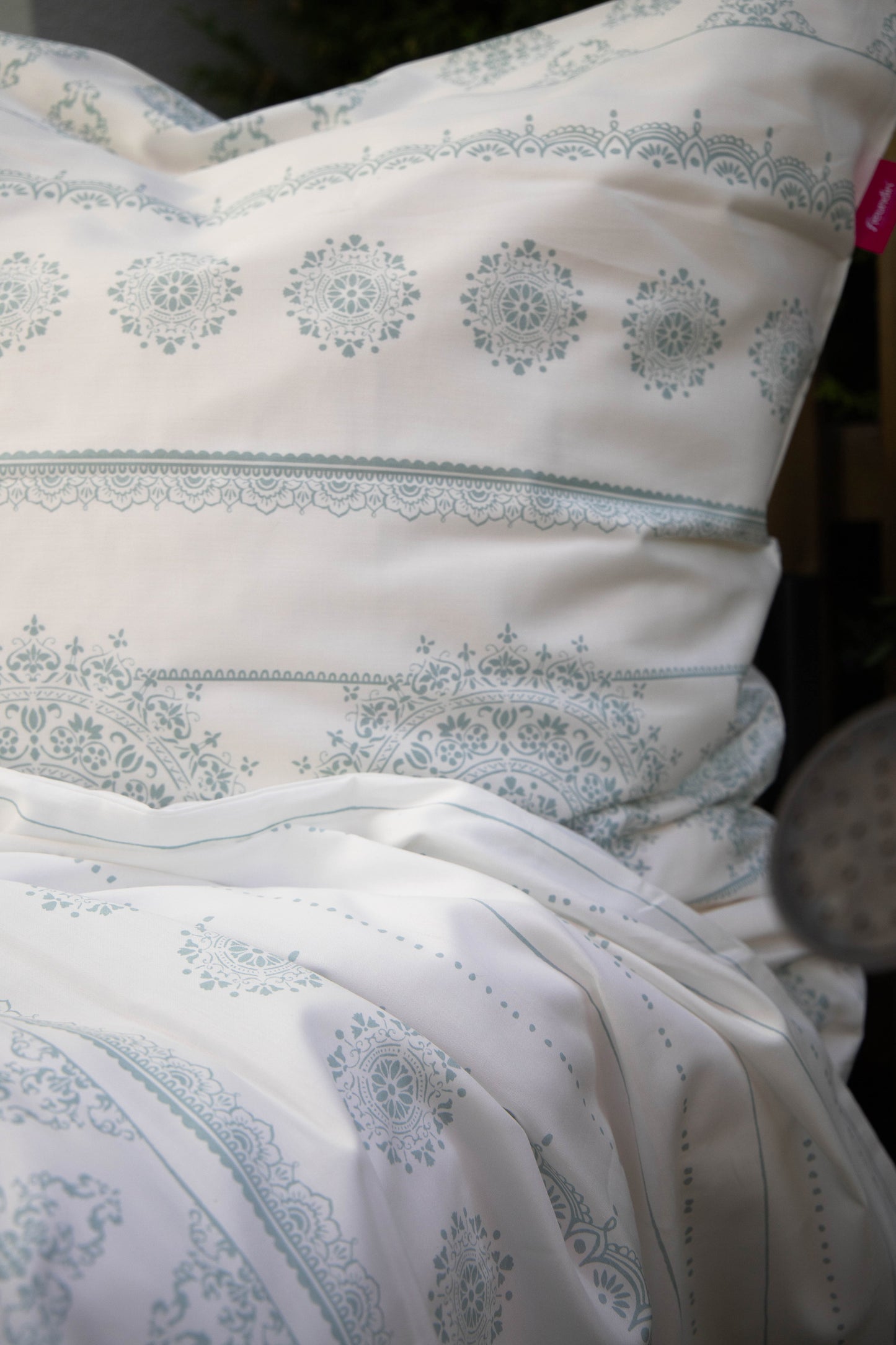 Detaildarstellung der geografischen Formen auf Kopfkissen und Bettdecke der Mako-Satin Bettwaesche Modell Freundin Home Collection Mint.