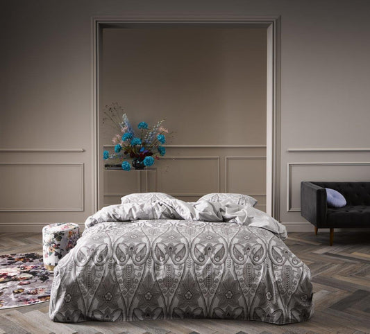 Ein Bettbezug-Set aus einem Kopfkissen und einer Bettdecke bezogen mit Perkal Bettwaesche aus 100 Prozent Baumwolle mit Muster aus Ornamenten in der Farbe Grau. Modell Dolley Grey.