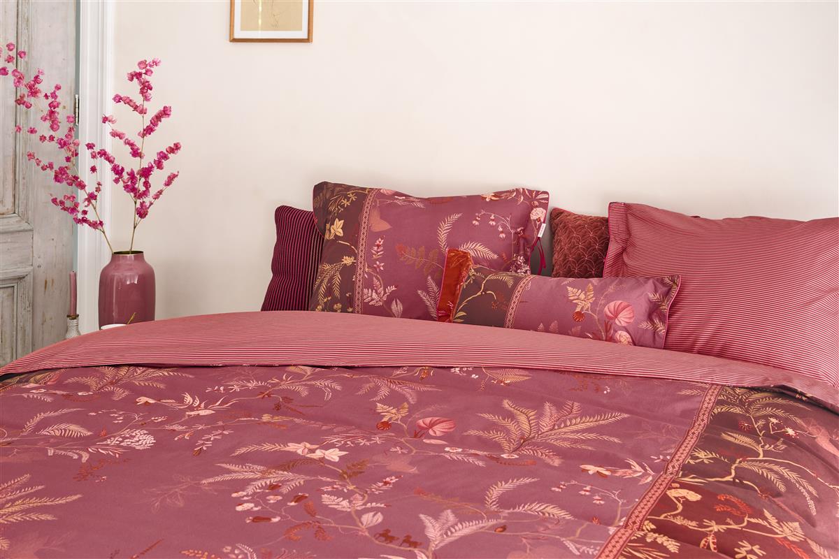 Ein Bettbezug-Set aus mehreren Kopfkissen und einer Bettdecke bezogen mit Perkal-Baumwoll Bettwaesche aus 100 Prozent Baumwolle mit Muster aus Pflanzen in der Farbe Pink. Modell Isola Pink.