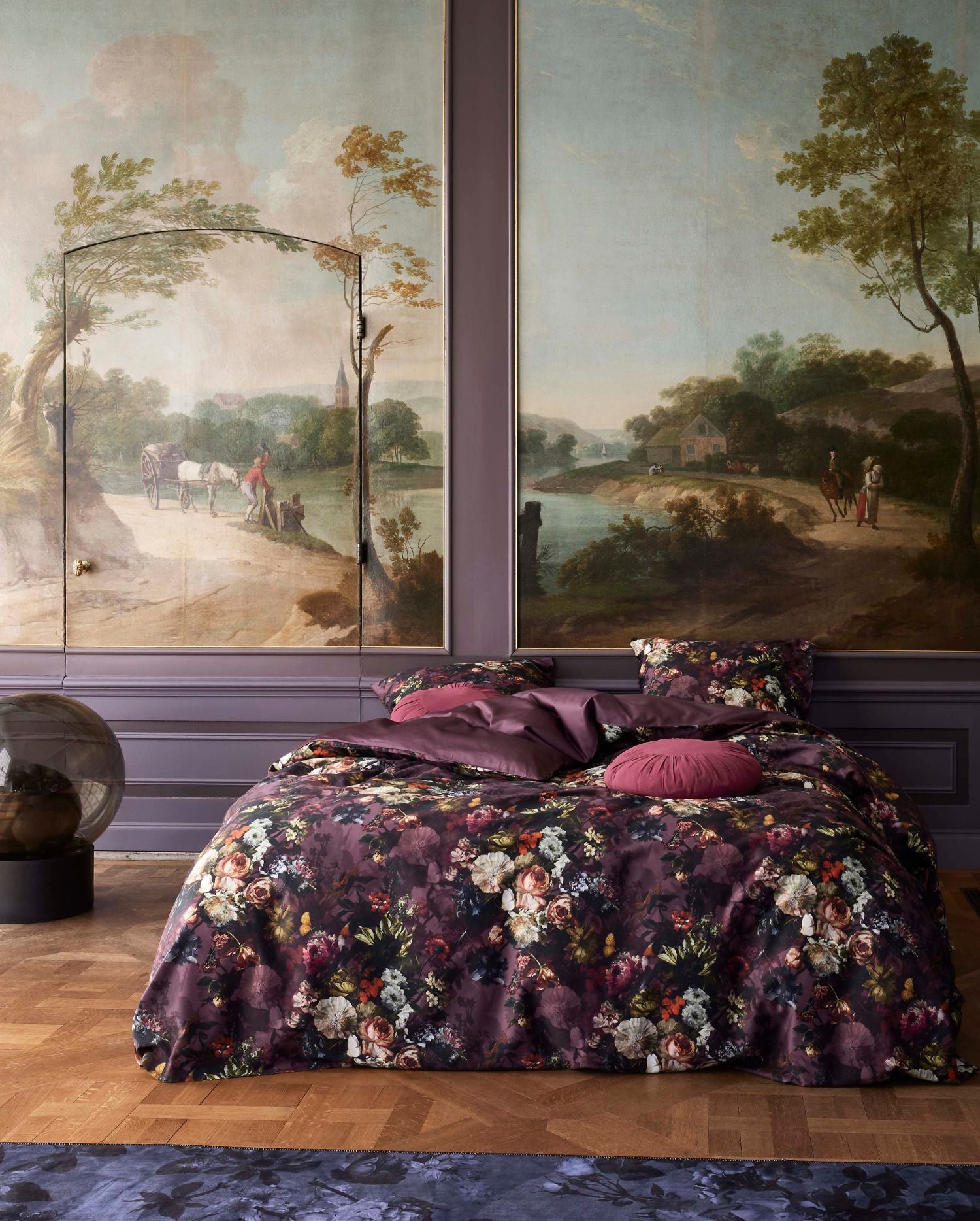 Ein Bettbezug-Set aus mehreren Kopfkissen und einer Bettdecke bezogen mit Satin Bettwaesche aus 100 Prozent Baumwolle mit Muster aus Blumen in der Farbe Lila. Modell Karli Purple Tulip.