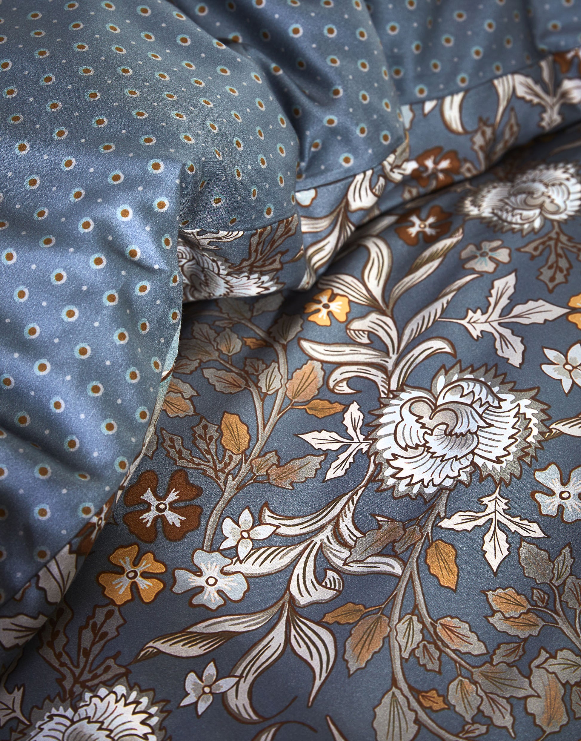 Detaildarstellung der Blumen und Punkte der Essenza Satin Bettwaesche Modell Ophelia Midnight Swim.