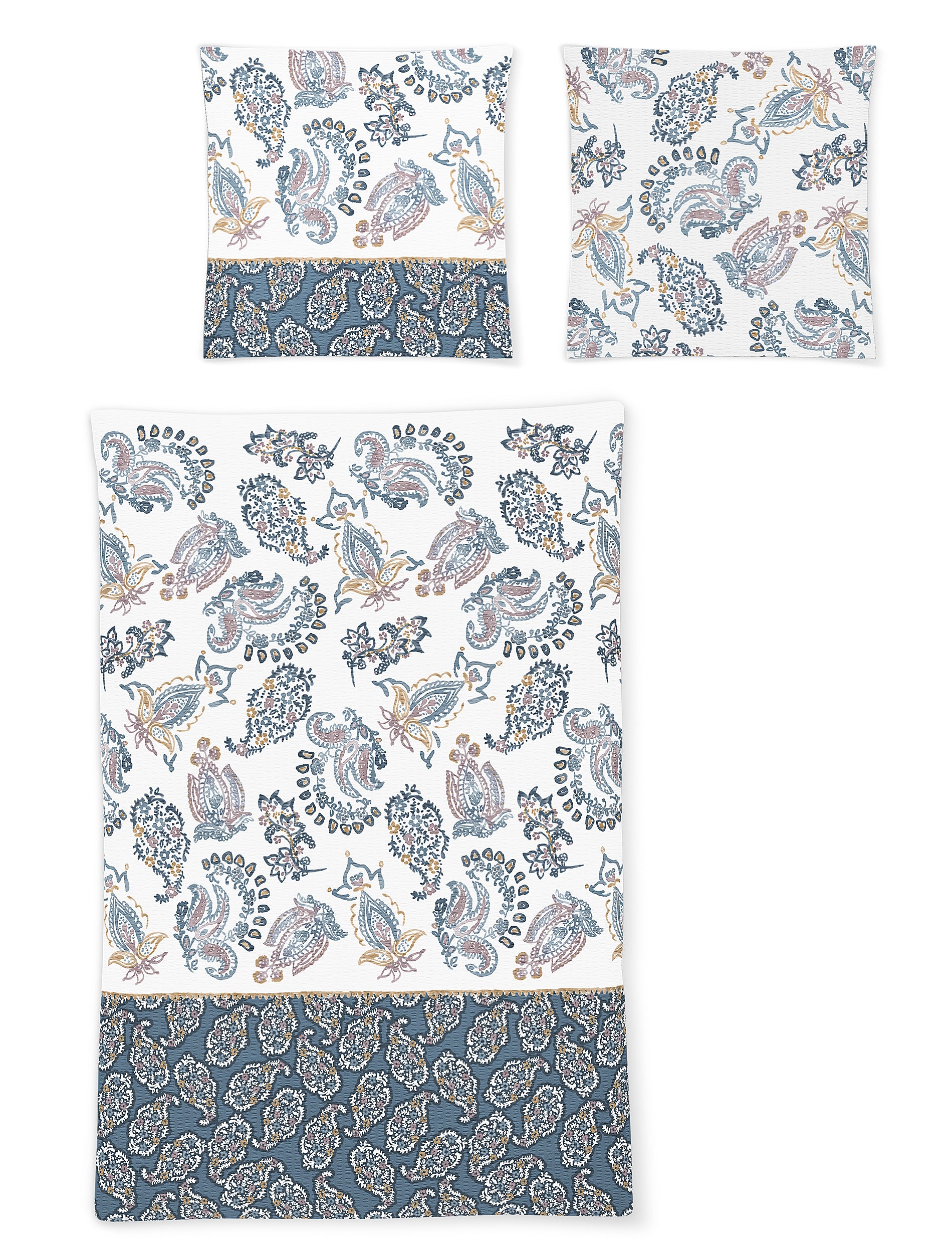 Zwei Kopfkissen und eine Bettdecke bezogen mit Soft Seersucker Bettwaesche mit einem Muster aus Ornamenten in der Farbe Blau. Modell Shadow Blue.