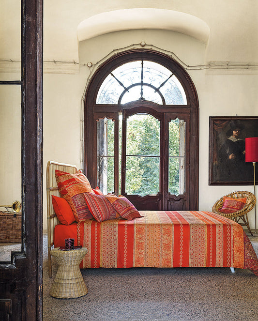 Mehrere Kopfkissen und eine Bettdecke bezogen mit eleganter Mako-Satin Bettwaesche von bassetti mit einem gestreiftem Paisleymuster in der Farbe Orange. Modell Italiana in Algeri G1.
