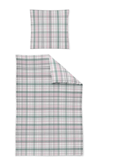 Ein Kopfkissen und eine Bettdecke bezogen mit Satin Bettwaesche mit einem Muster aus Quadraten in der Farbe Rosa. Modell Karo Rosa Gruen.